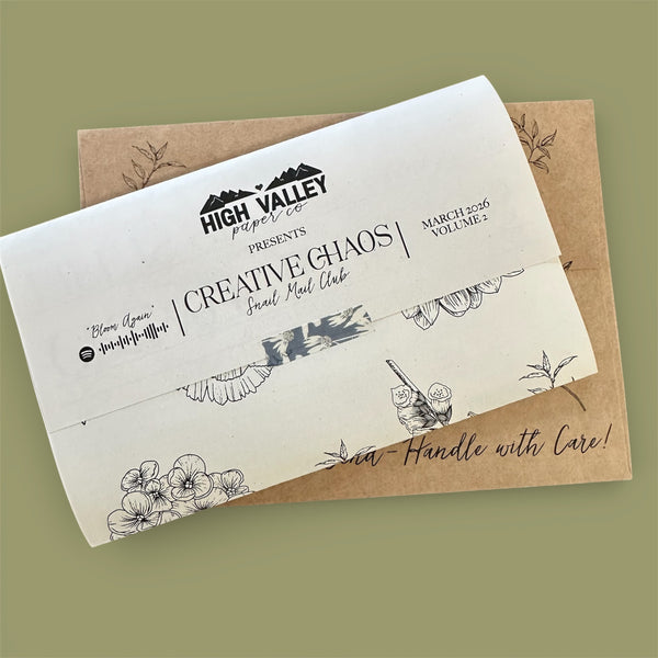 Envelopes with artistic designs and 'High Valley Paper Co.' branding on a green background